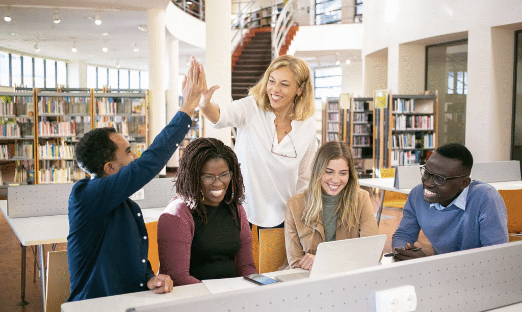 Students high-fiving a professor, celebrating connection and success through engaging campus events
